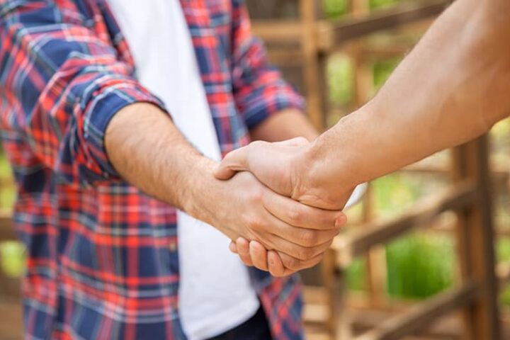 Close-up of two men shaking hands