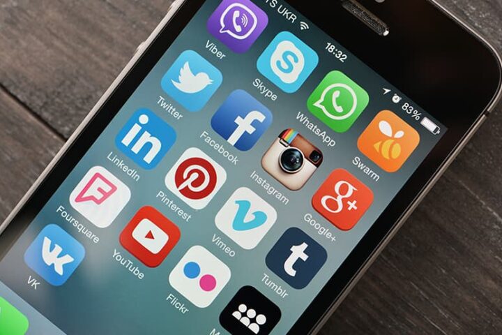 Close-up of iPhone screen with social media apps