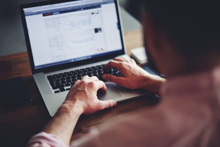 Man looking at information on a computer