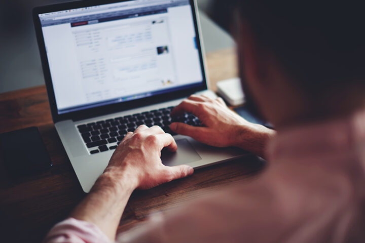 Man looking at information on a computer