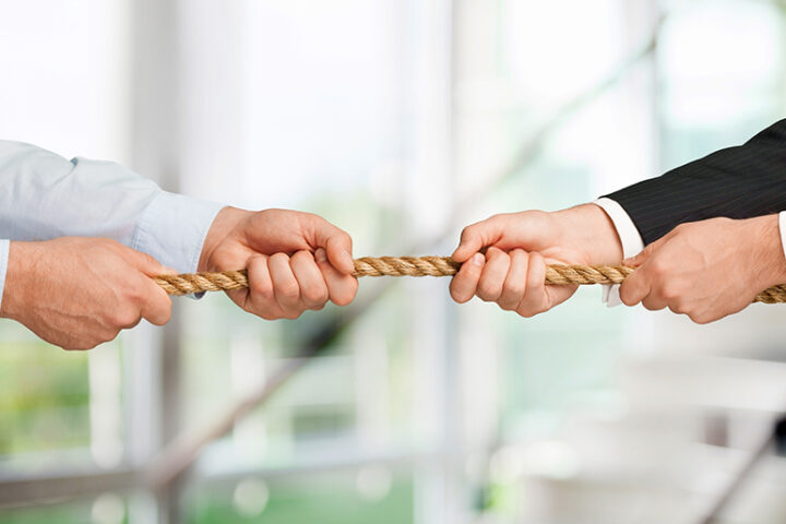 Close-up of white, male hands tugging on a rope
