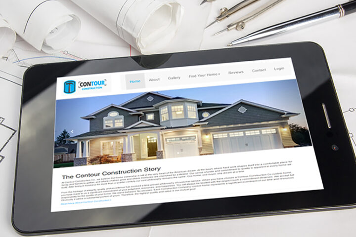 "The contour construction story" on a tablet on a table with blueprints