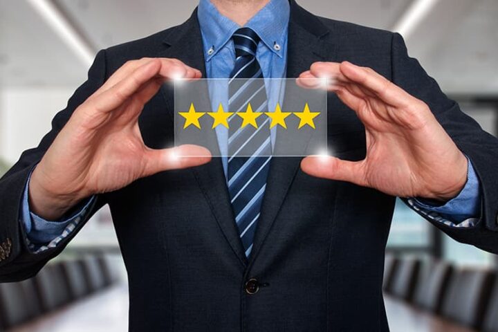 Business man holding five star rating