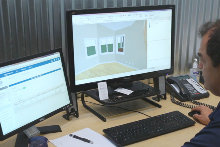 Man looking at two monitors