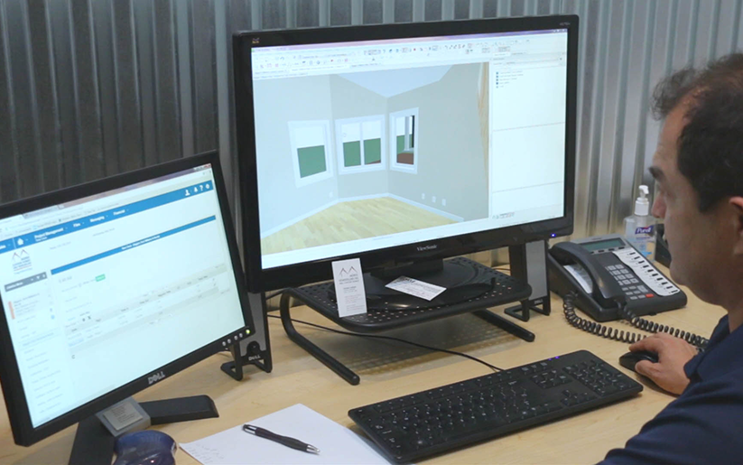 Man looking at two monitors