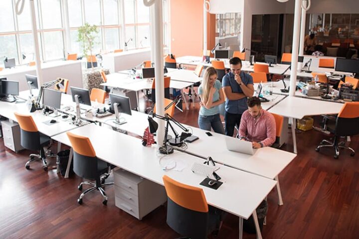 Employees gathered working in office space.