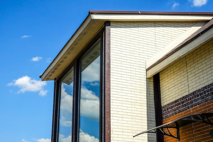 Cottage with panoramic large Windows. Glazing of the facade of the house. Tinted glass.