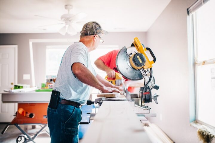 Two people using power tools