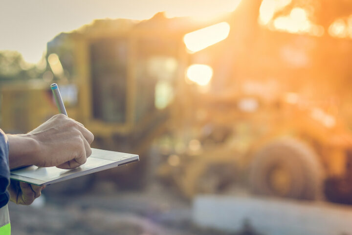 Person using a tablet in constuction field.