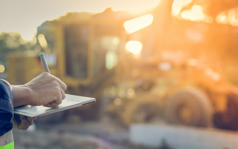 Person using a tablet in constuction field.