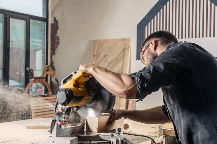 Carpenter working with buzz saw.