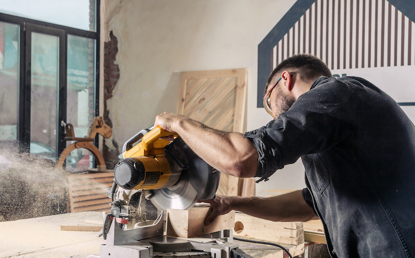 Carpenter working with buzz saw.