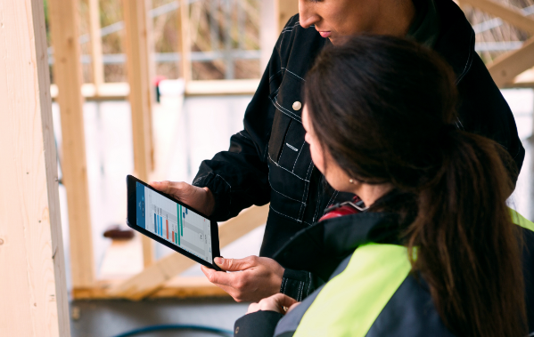 Two people looking at a tablet