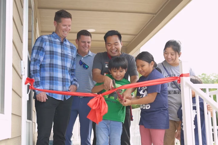 Habitat for Humanity group cutting ribbon