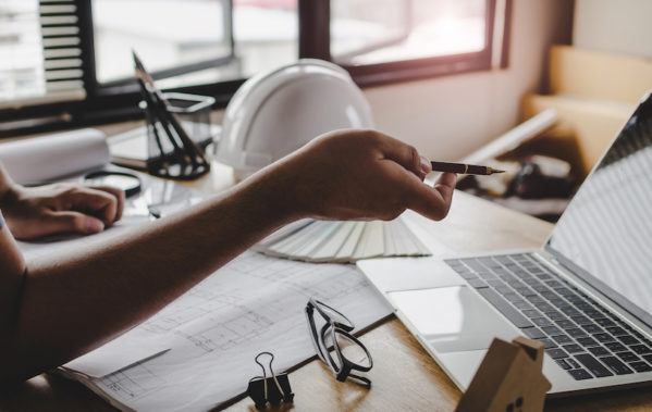 Man working on project management system for home construction
