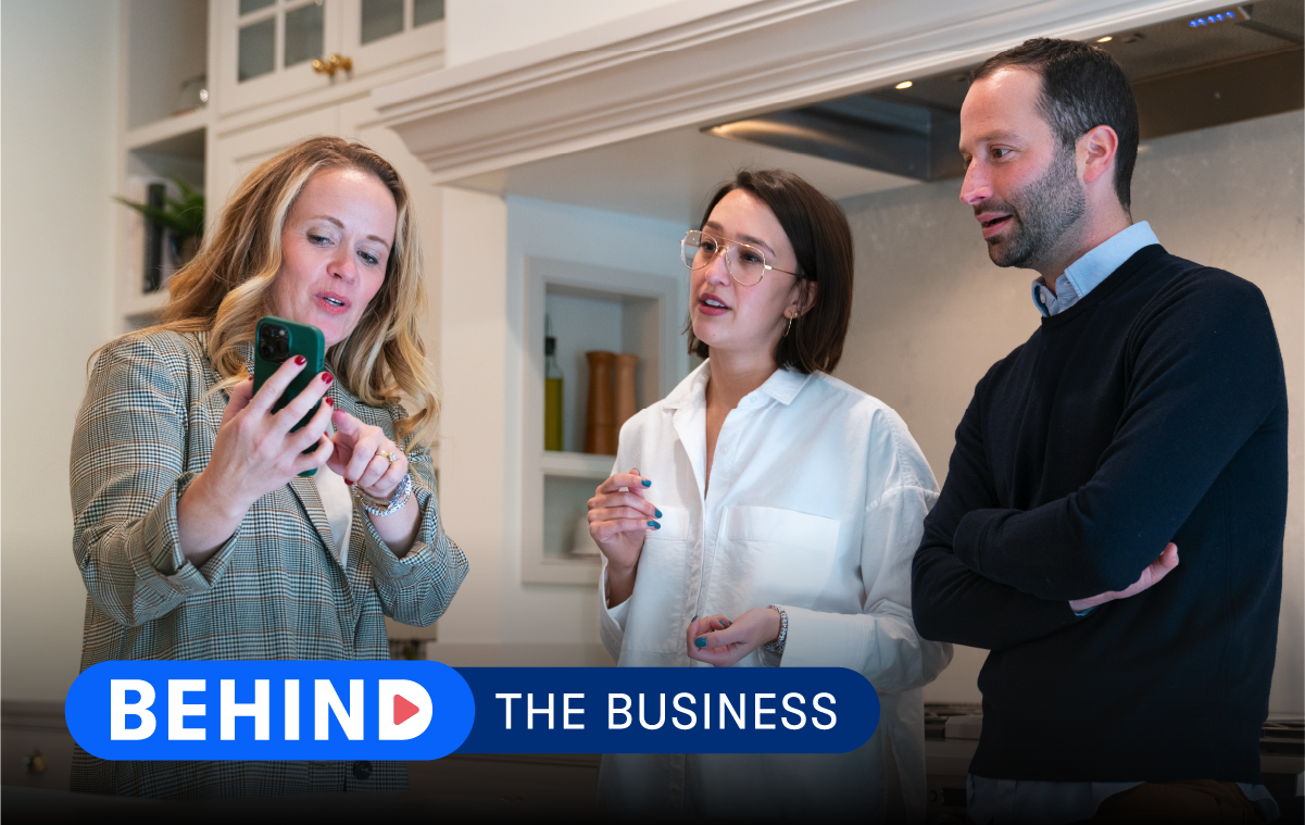 Katie Kath of Jkath Design Build + Reinvent shows home buyers a communication tool like Buildertrend on her phone