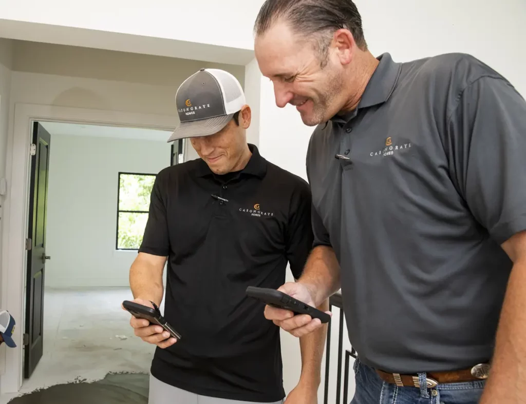 Cayson Graye Homes men looking on mobile