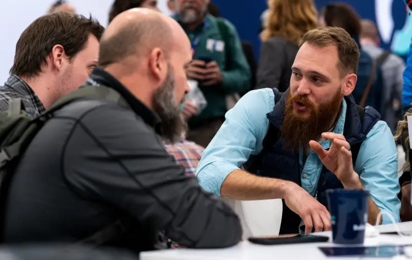 Two men talking at IBS 2023