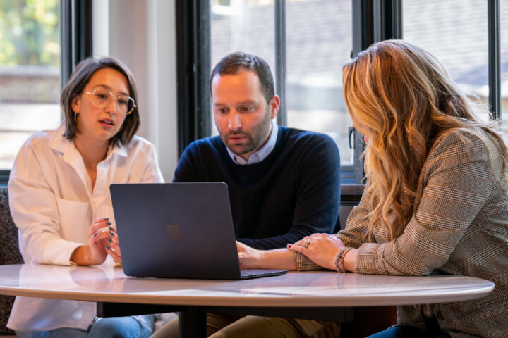 Home builder meets with two clients