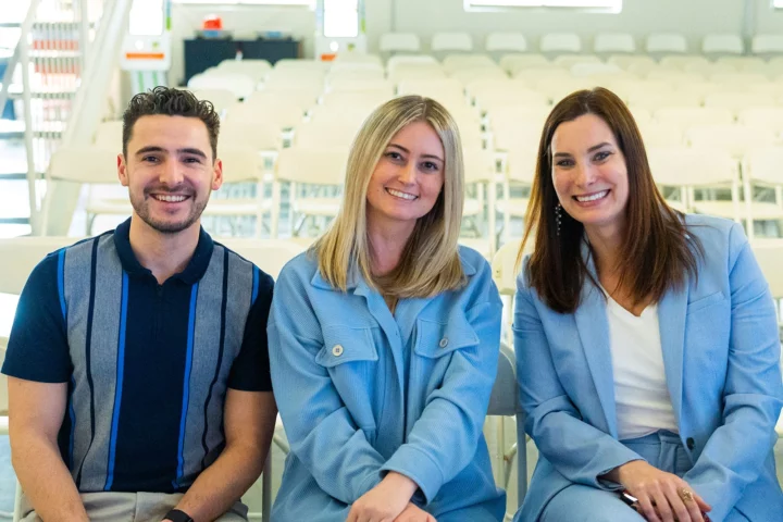 3 Buildertrend Legal employees sitting next to each other smiling