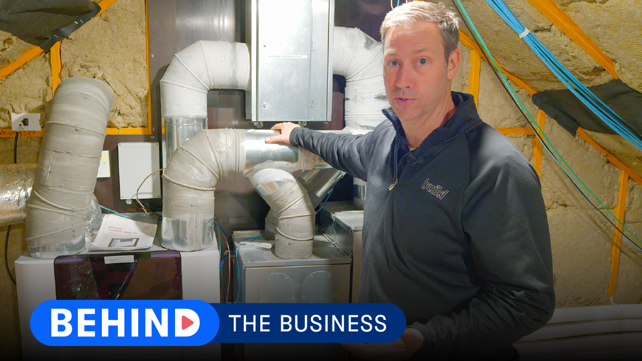 Risinger builder talking to the camera and Behind the Business logo at the bottom.