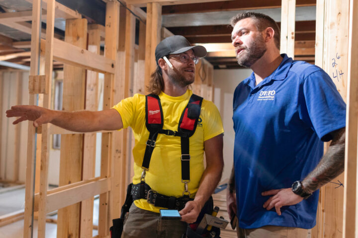 Two general contractors having a conversation on a job site.