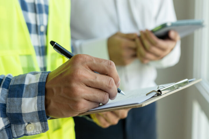 A home builder signing a lien waiver on a construction job site