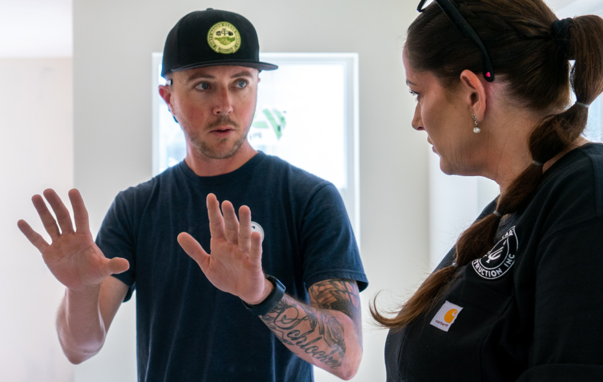 Two builders talking to one another.