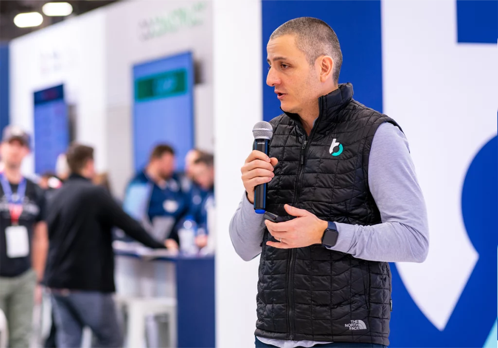 Man holding a microphone hosting a discussion