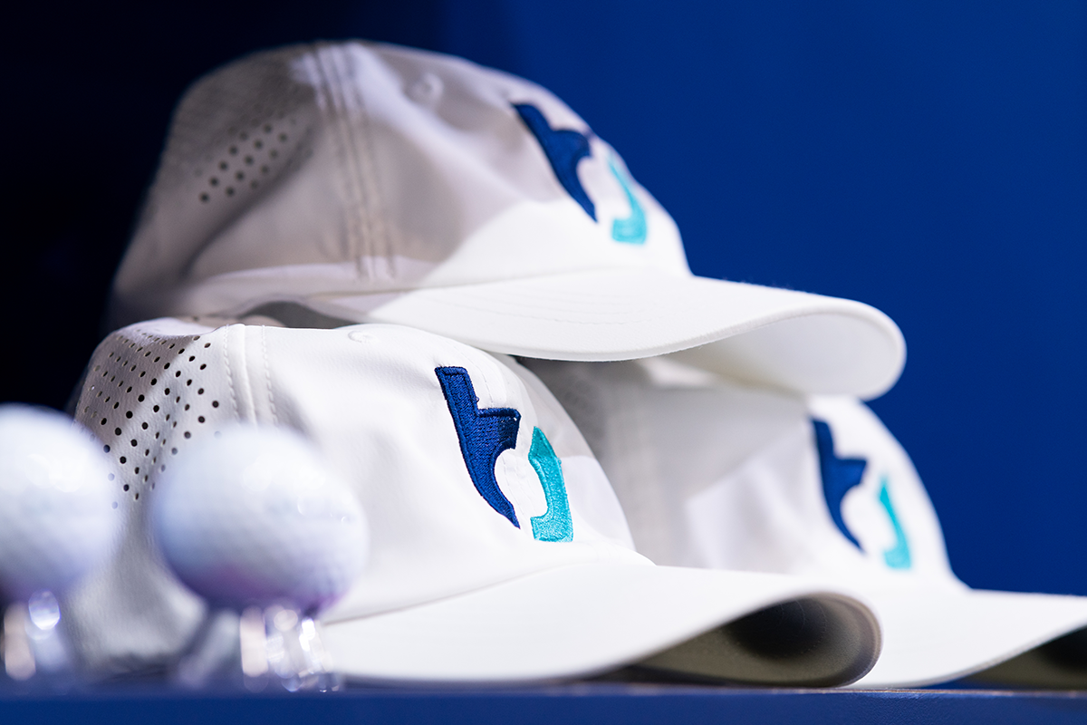 Stack of white hats with Buildertrend logo