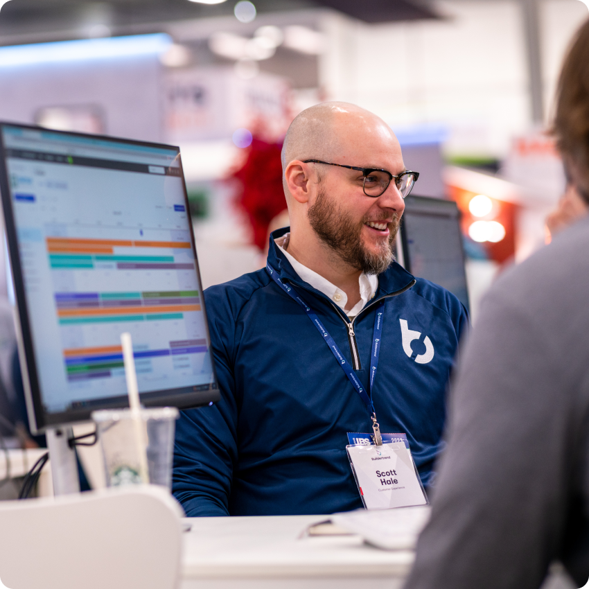 Buildertrend employee in front of computer screen giving product demo