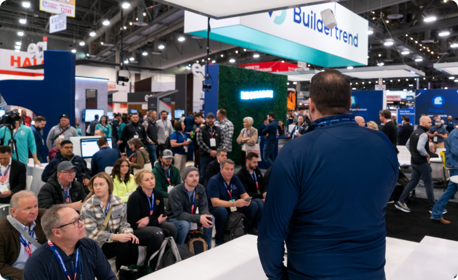 Host speaking in front of audience at IBS