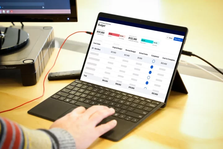 A person on their laptop using cost plus software