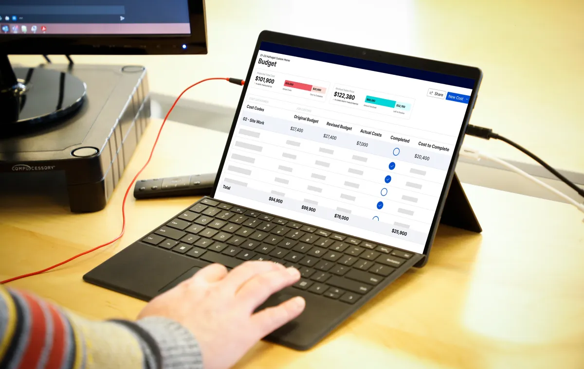 A person on their laptop using cost plus software