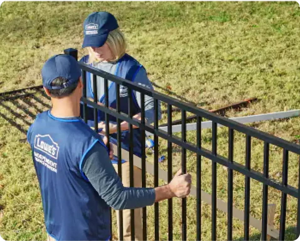 Lowe's team members working on fence install
