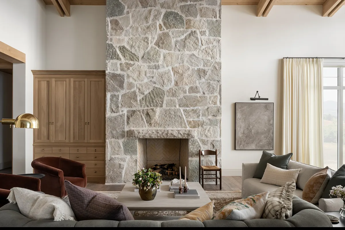 Home interior living room with stone fireplace feature