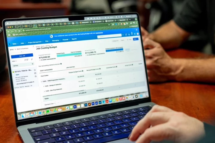 A laptop computer with Buildertrend line item software on the screen
