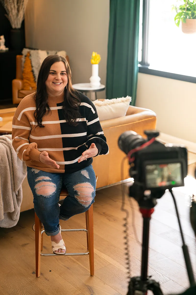 Woman in living room sitting in front of camera