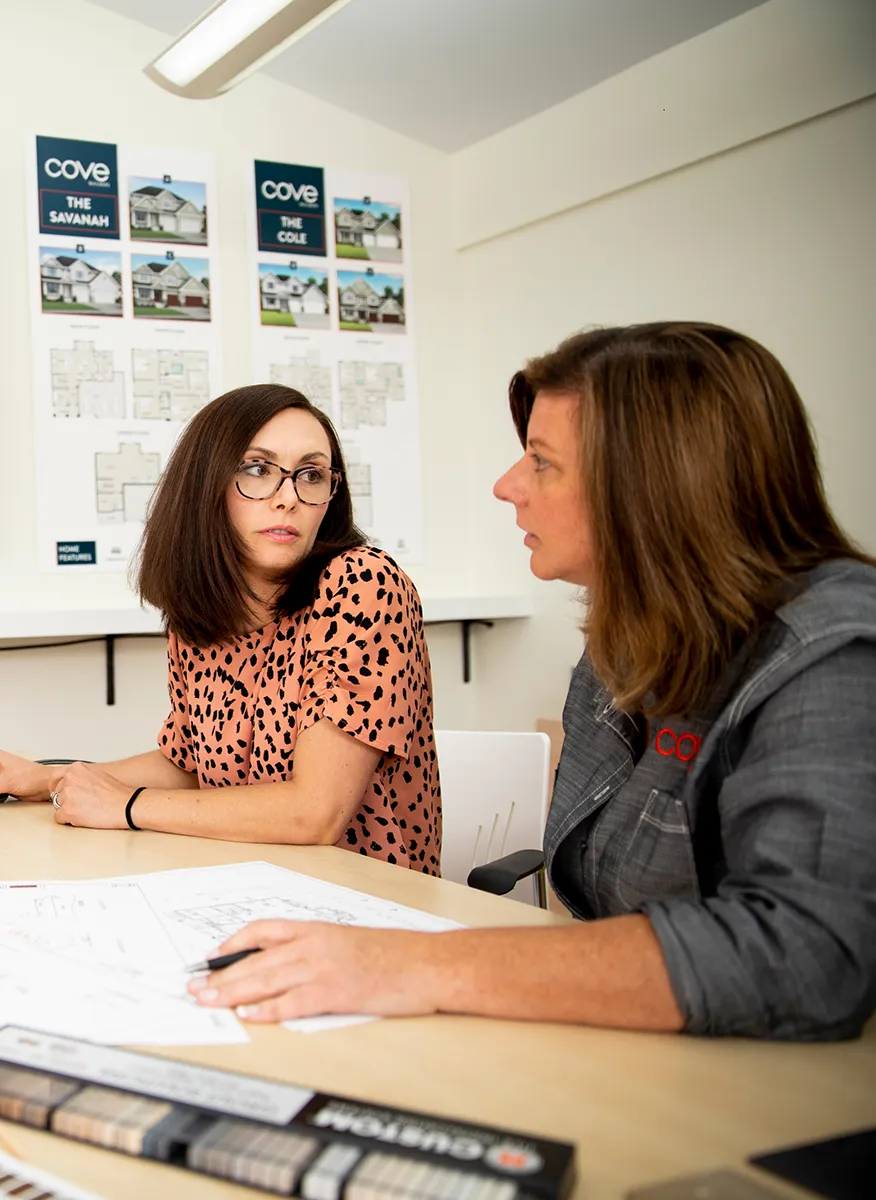 Two women sitting at a table having a discussion