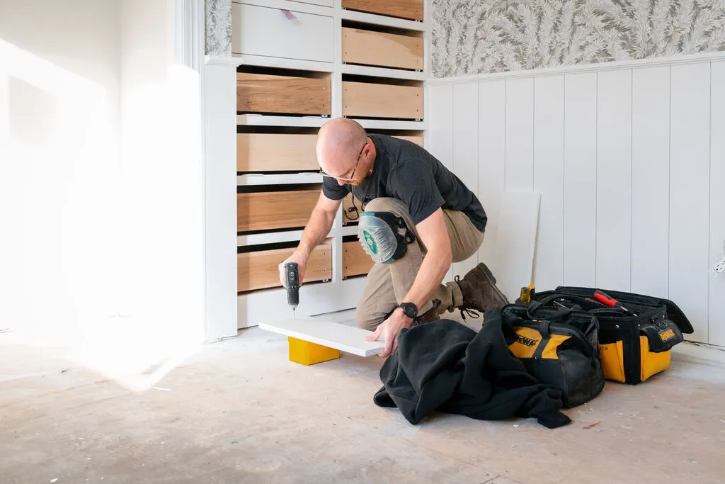 Man kneeling on floor working