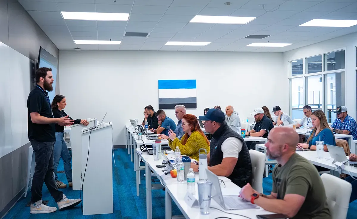 Man and woman presenting to a Buildertrend University class