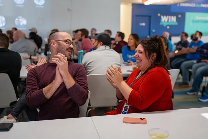 Man and woman sitting next to each other at table enjoying conversation