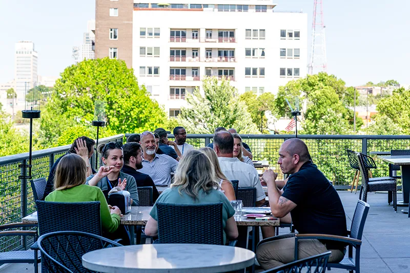 Group of people sitting outside on patio