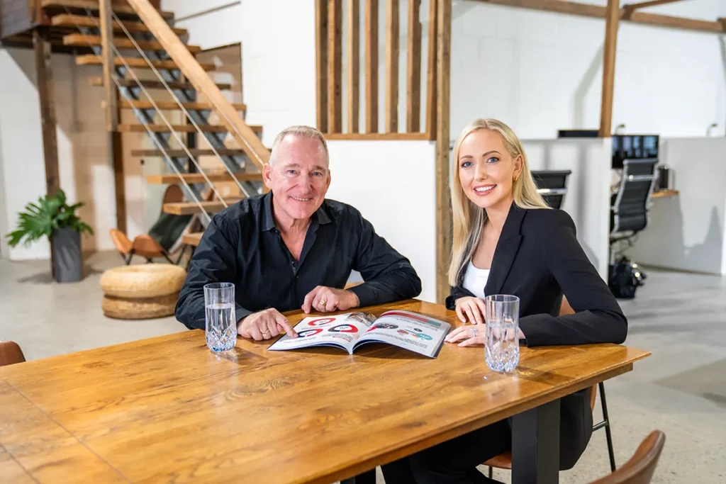 Man and woman sitting at bench table