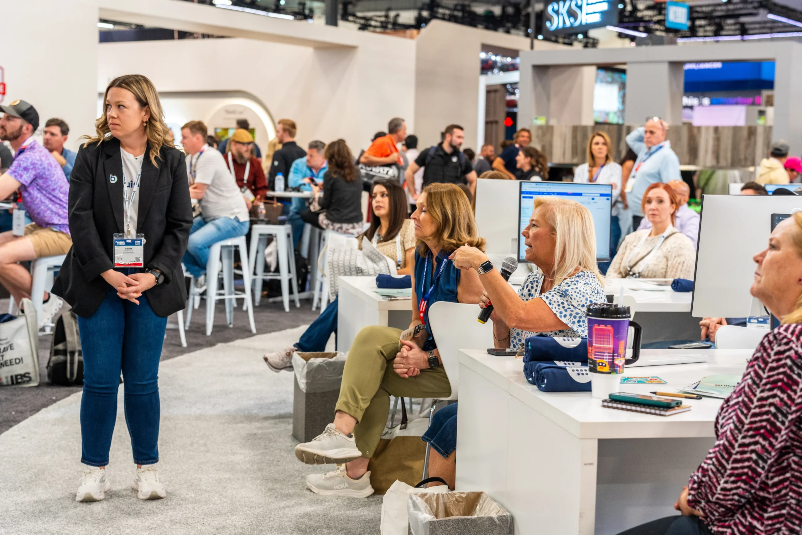 IBS 2025 participants listening at booth