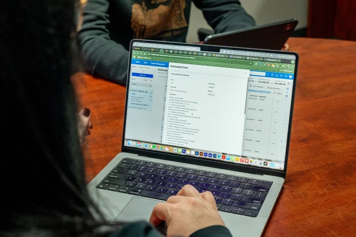 Woman looking at Estimated Cost screen on the Buildertrend app