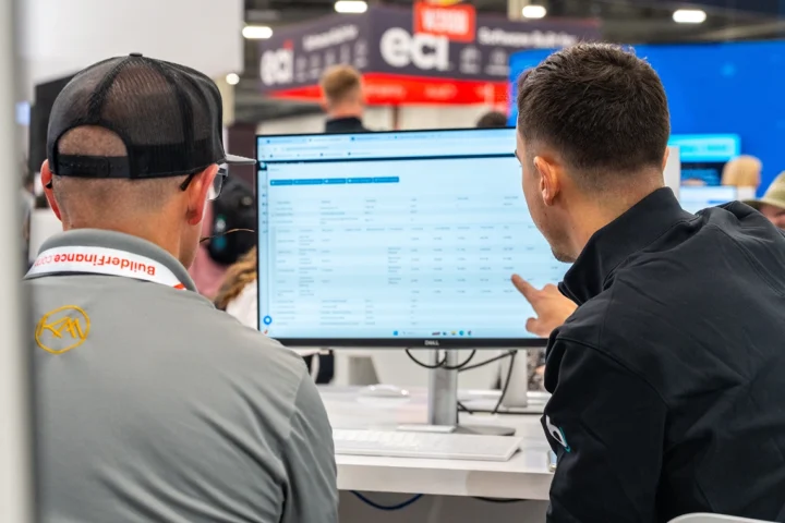 Two men looking at a desktop screen during IBS