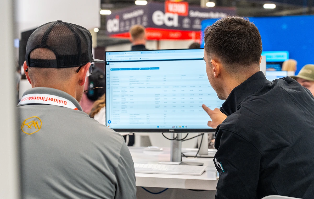 Two men looking at a desktop screen during IBS