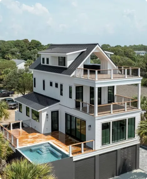 Home exterior featuring an outdoor pool over the garage