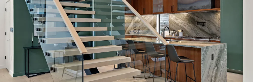 Wooden staircase with glass side railings and wooden handles